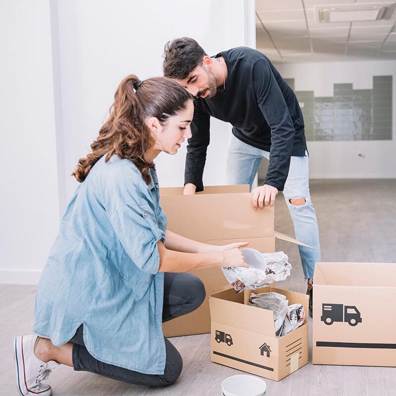 Couple packing boxes for a man and van move